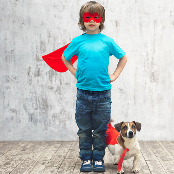 Kind Kid dressed as superhero with dog